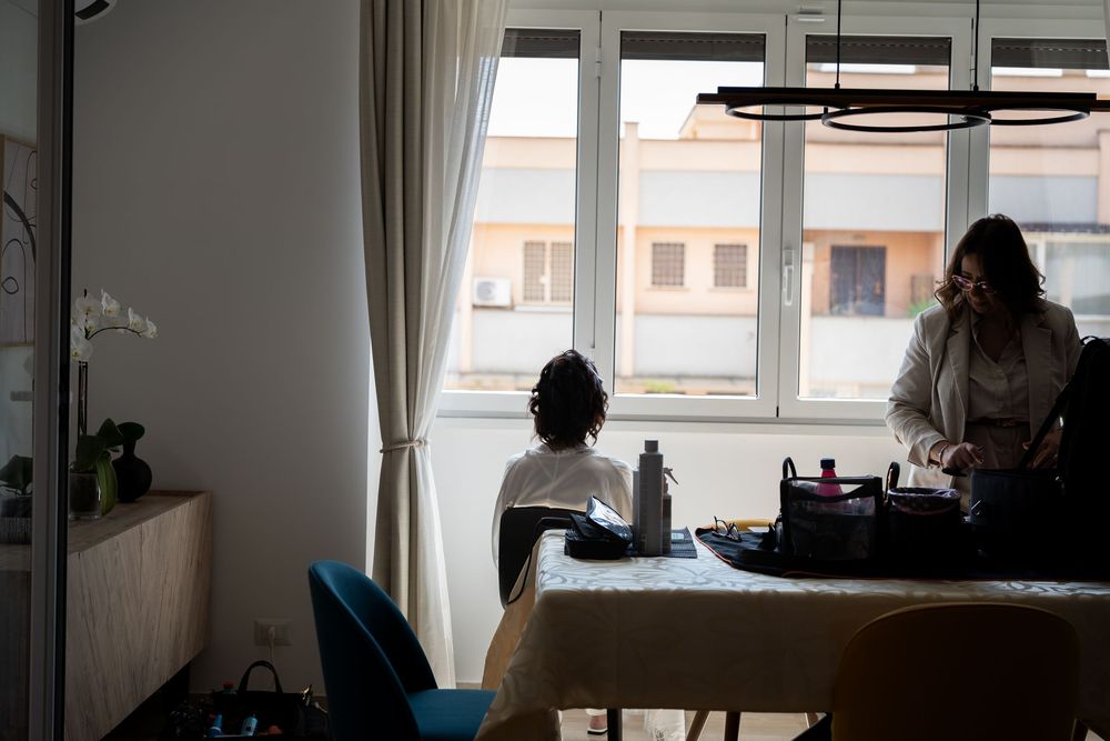 Silhouettes of people against bright windows in modern interior room.
