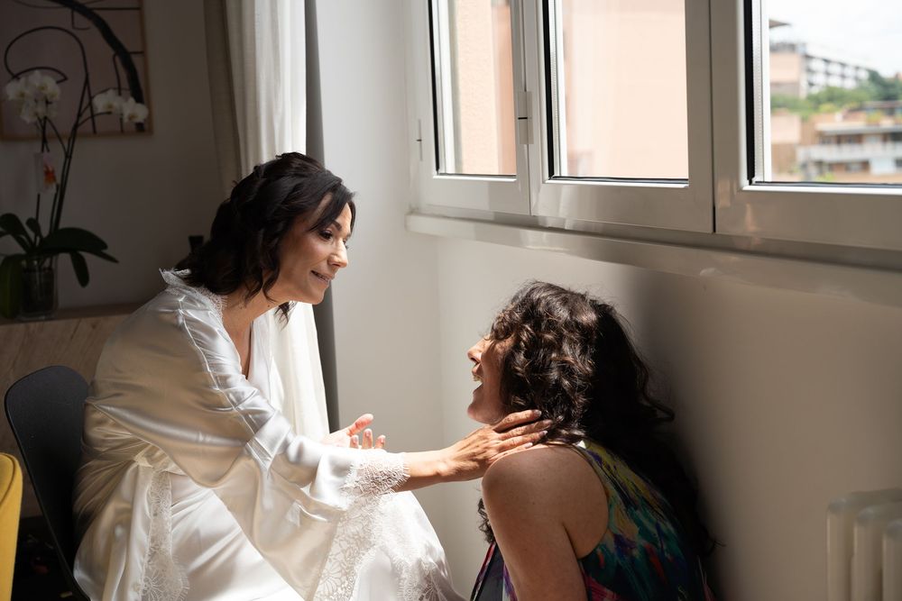 Sunlit wedding preparation scene through window with natural lighting.