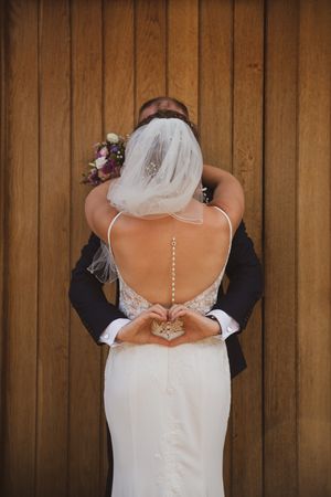 Back views of a wedding dress with decorative button details along the spine shown in multiple angles.