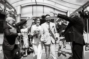 A panoramic collage of black and white wedding photos showing candid moments and celebrations during a reception.