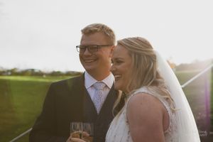 Bride and groom share intimate moments together during golden hour outdoor wedding photography session.