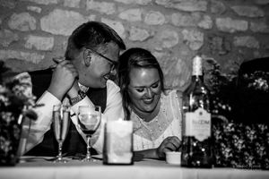 Several black and white wedding photos show intimate moments captured between the bride and groom during a reception.