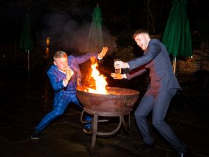 Sequence of people gathering around a fire pit on a patio at dusk with green umbrellas in the background.