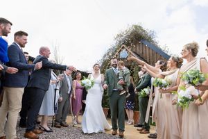 Wedding party celebrates with joyful group photos outdoors on a bright sunny day.