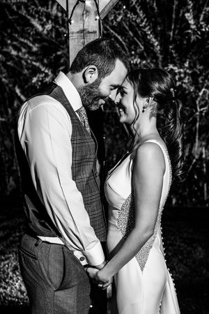 Intimate black and white wedding portraits captured in a natural woodland setting.