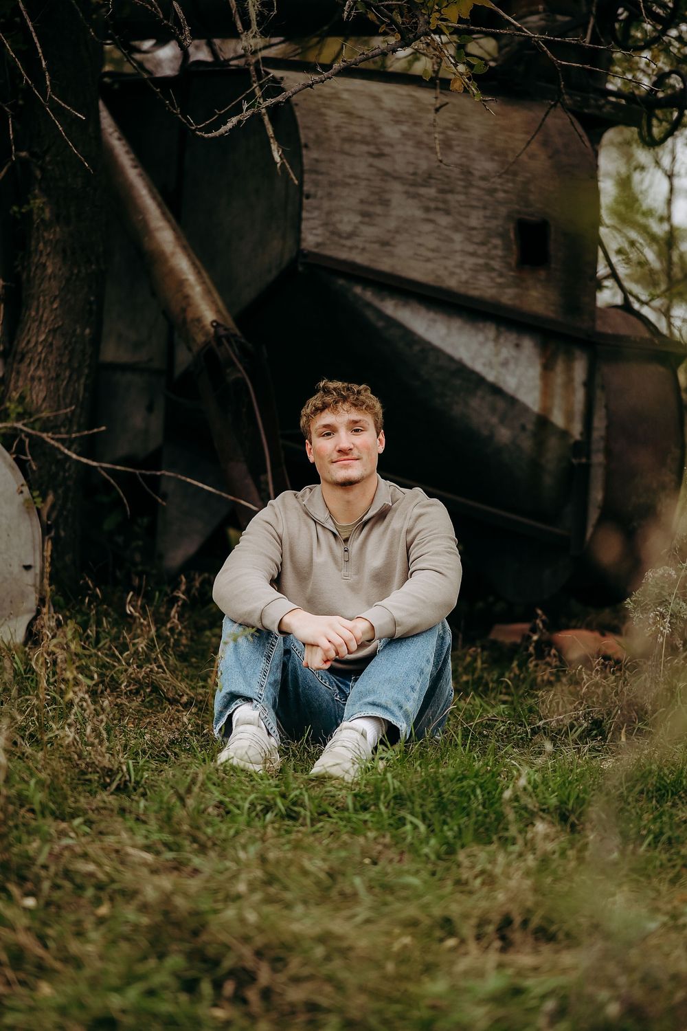 A series of outdoor portrait shots showing someone sitting in grass near a brick wall.