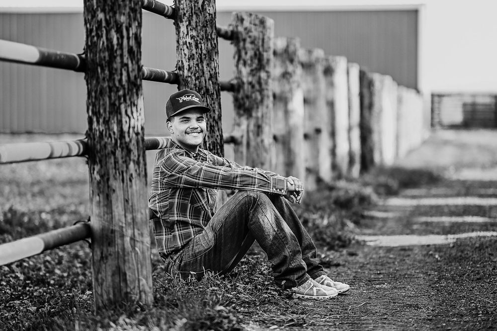 A series of black and white photos showing someone resting against a tree trunk in different poses.