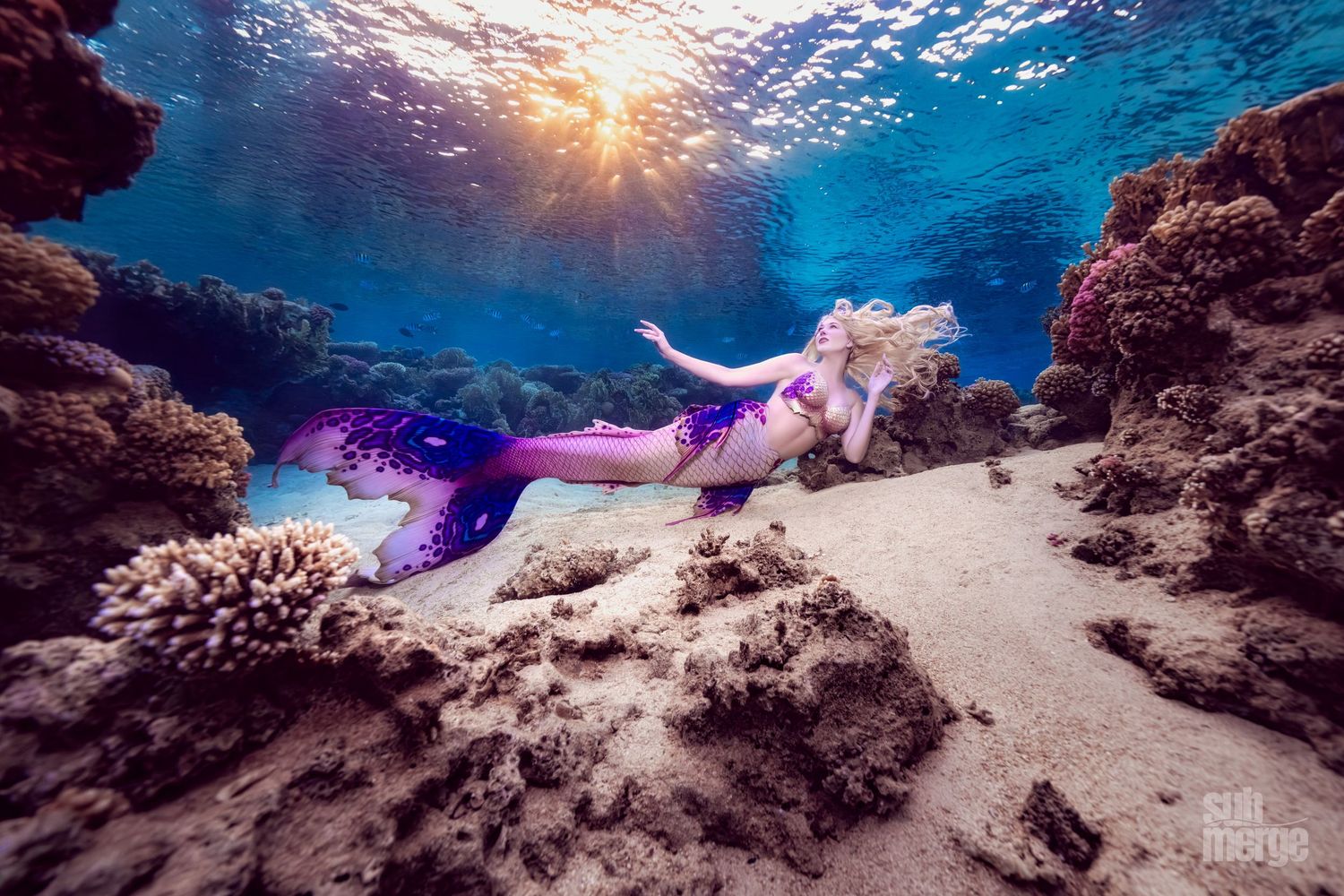 Ethereal underwater scene at sunset with natural rock formations and dreamy light rays filtering through blue water.