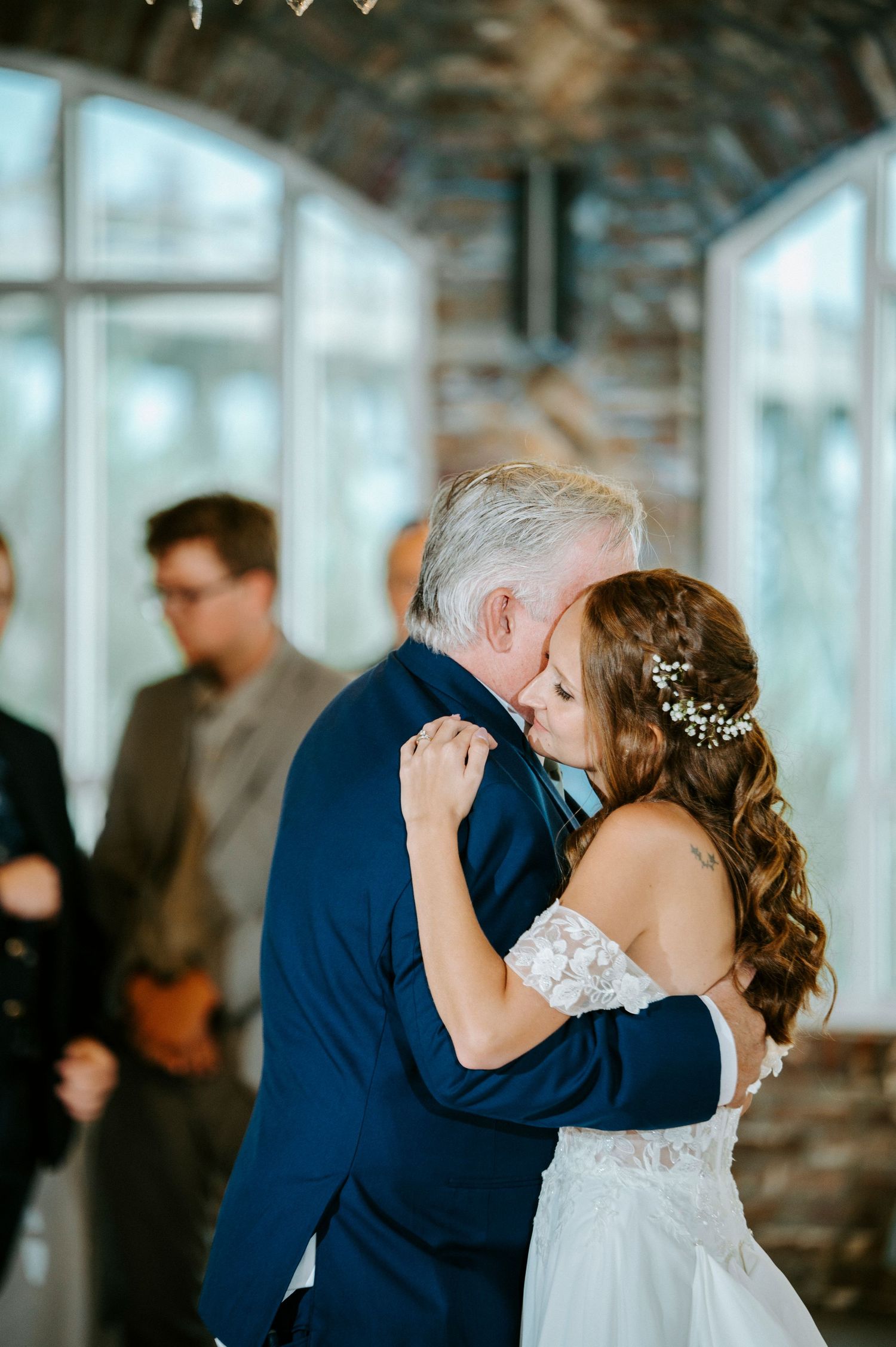 A wedding celebration featuring romantic dance moments in a rustic venue with twinkling lights.