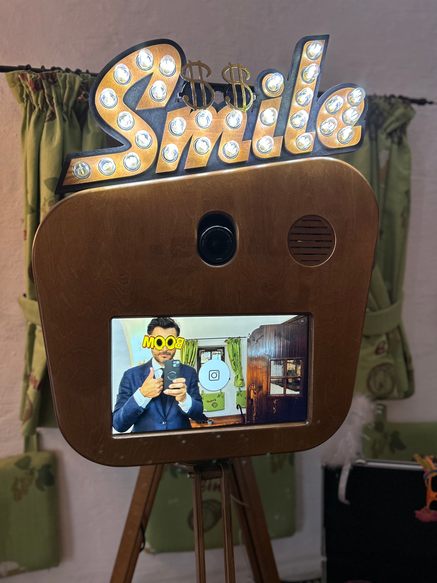 A vintage-style retro marine photo booth display featuring decorative light bulbs and a rustic brown wooden design.