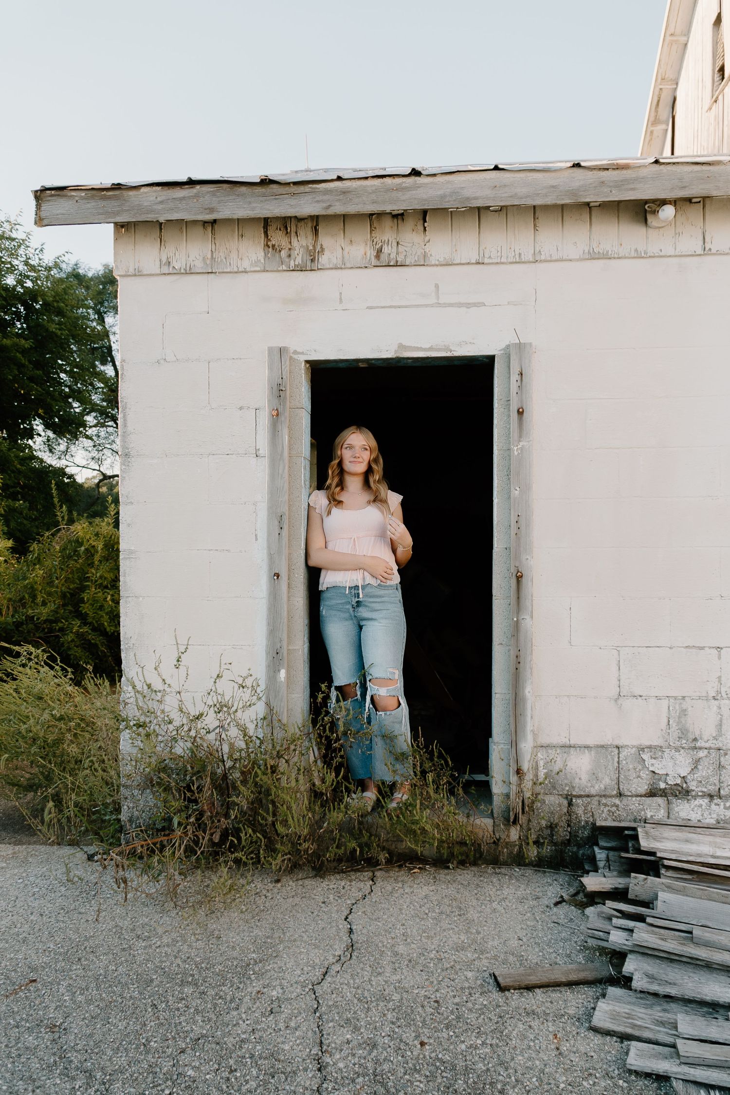 A sequence of five photos shows a person stepping out of a concrete doorway in an abandoned building.