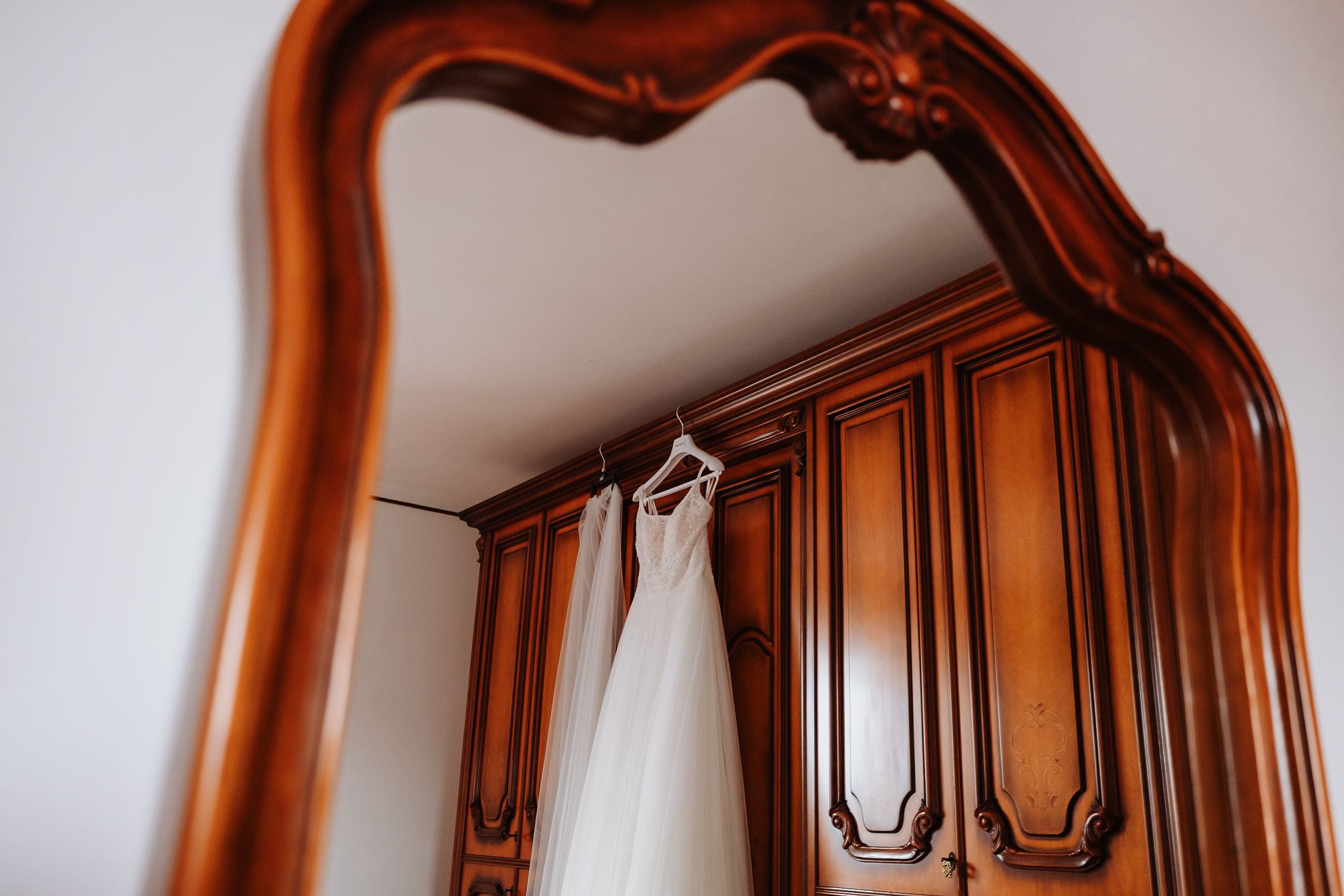 Ornate wooden door and wall panels with intricate trim details in rich brown tones create elegant interior molding.