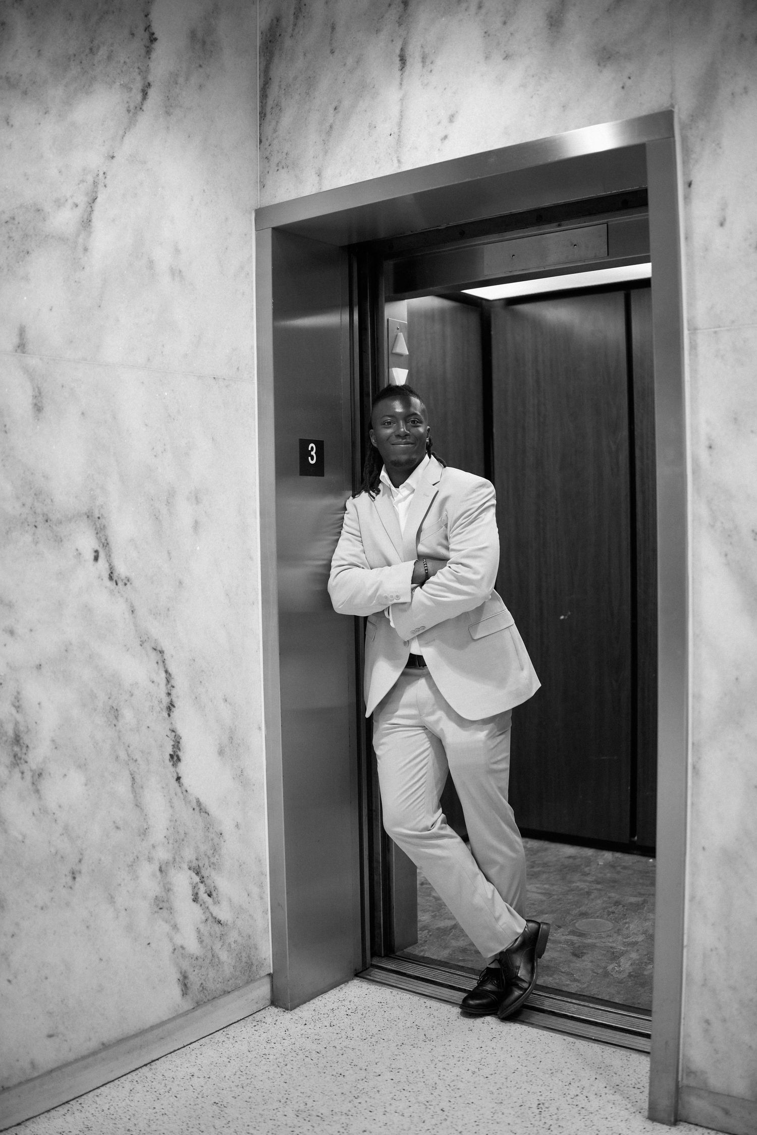 A sequence of four photos showing a person in white attire performing playful poses while entering an elevator.