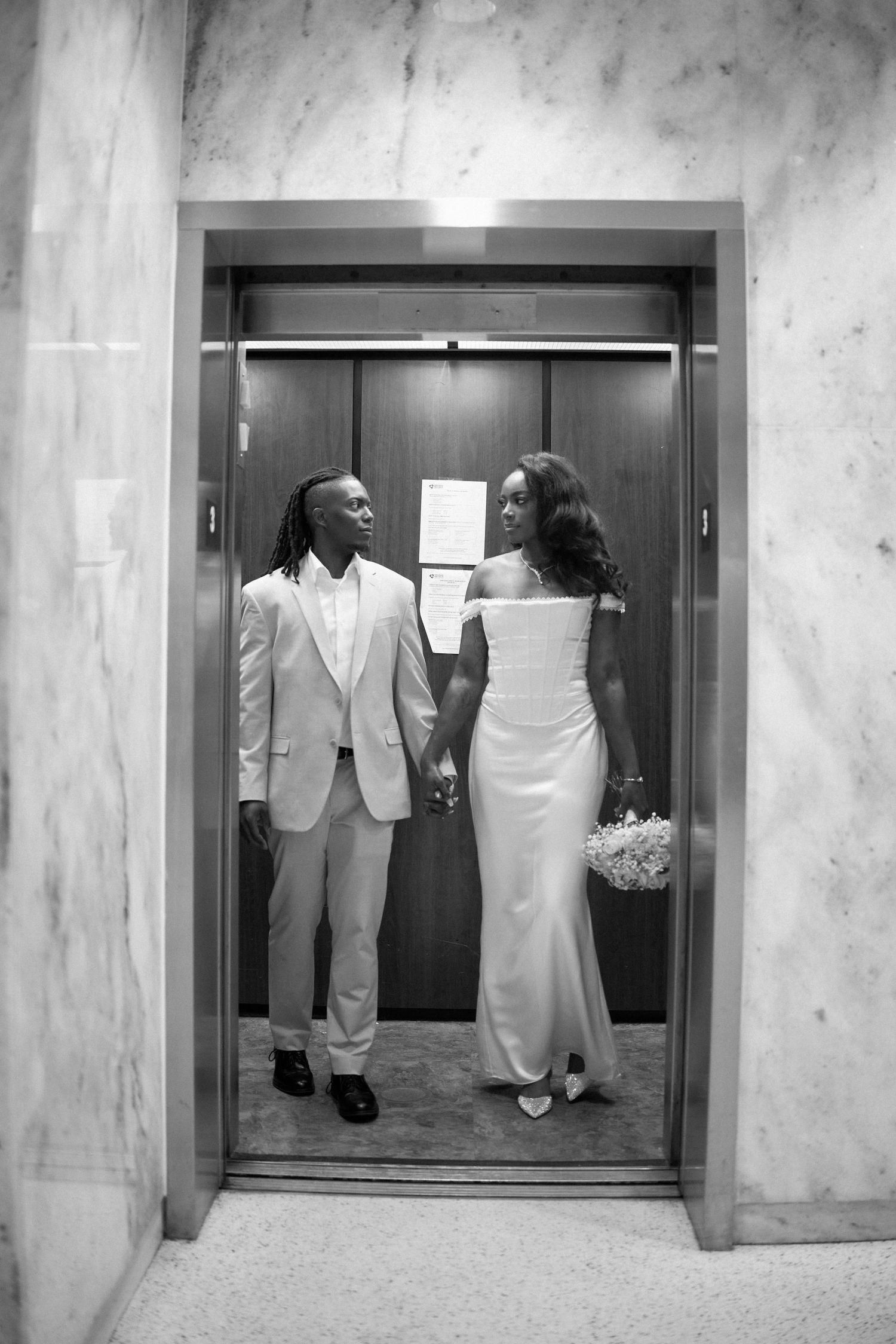 A series of elevator photos showing a couple interacting in a romantic sequence against white marble walls.