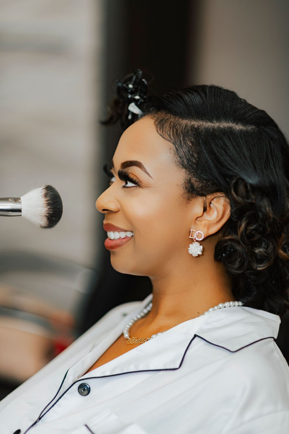 A series of profile shots showing someone wearing a white blazer with black trim and sparkly earrings.