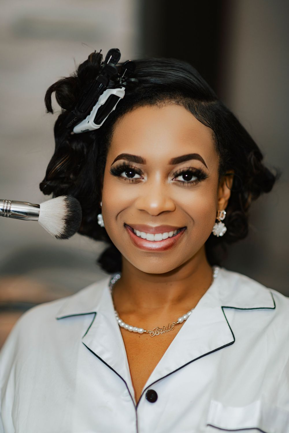 Professional headshot series showing a bright smile and elegant white blazer with black trim.