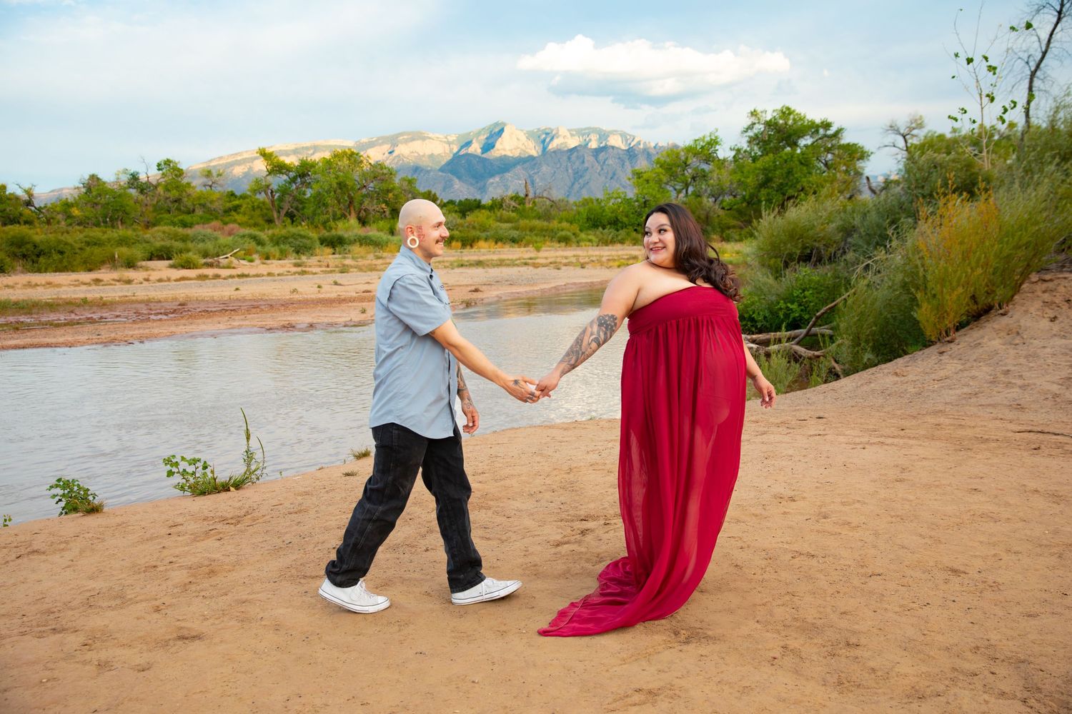 A romantic desert photoshoot sequence showing flowing red fabric against a scenic mountain backdrop.
