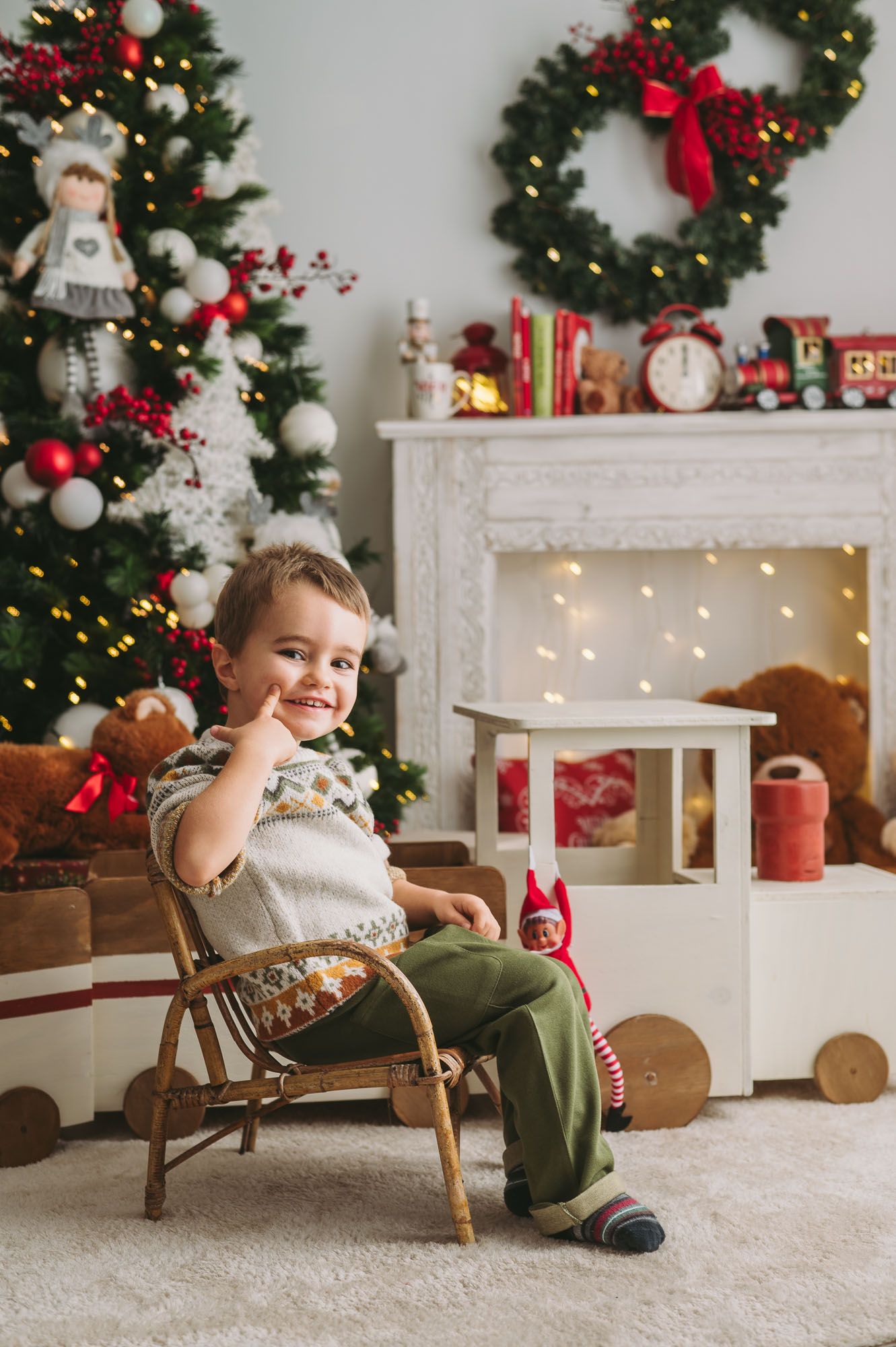 Joyful holiday scene in rattan chair with Christmas decorations.