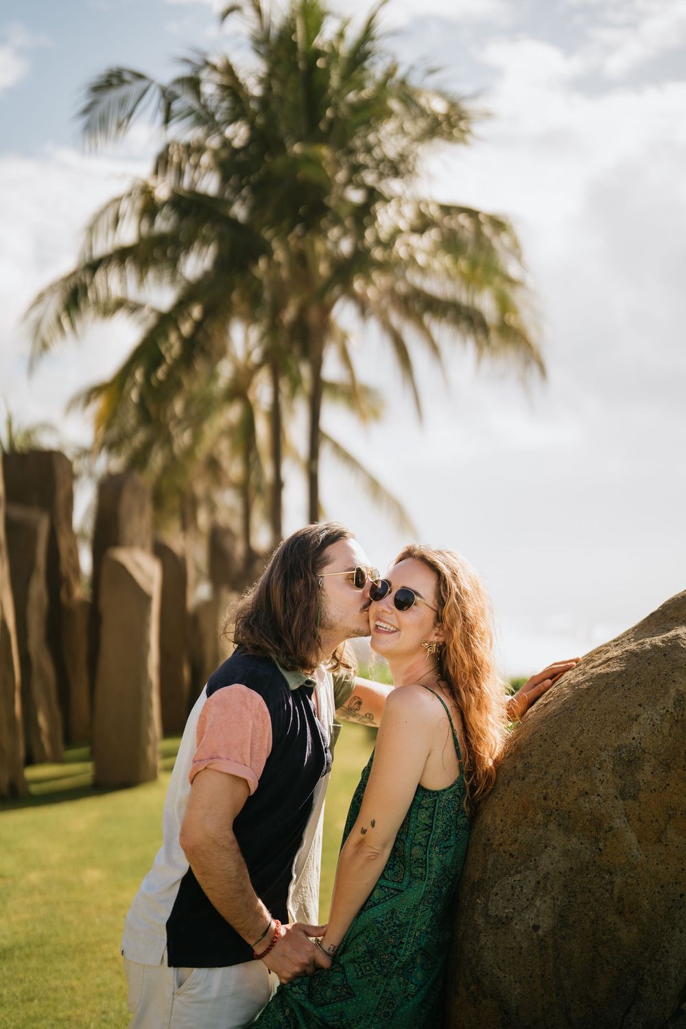Romantic beach scene with palm trees and golden sunlight creating a tropical atmosphere.