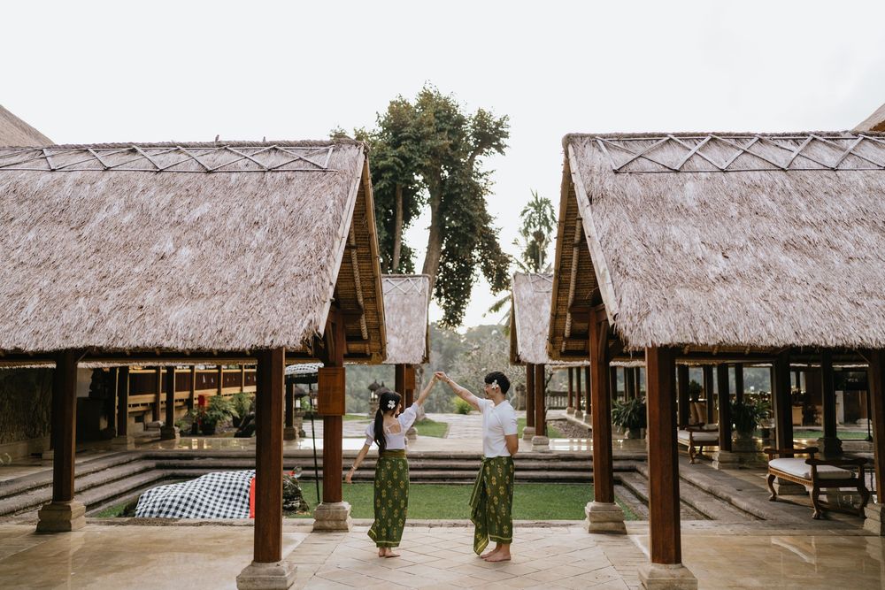 A row of traditional thatched-roof huts along a beachfront property.