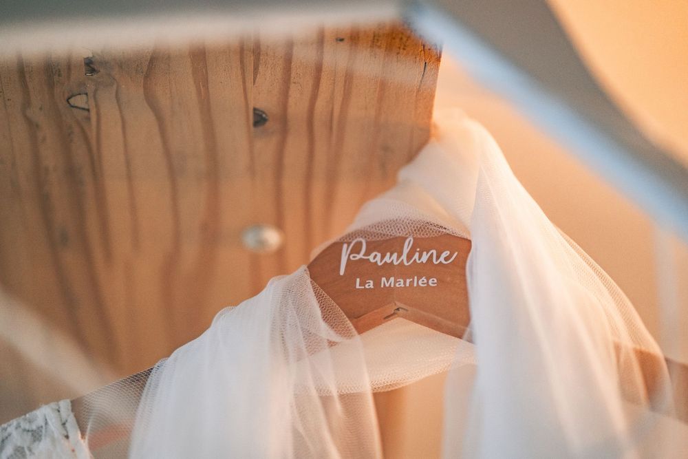 Vintage wedding gown detail shot with veil in soft natural lighting.