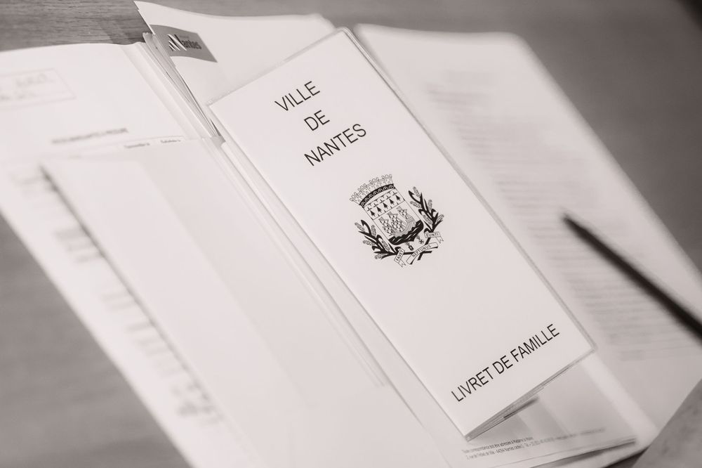 White paper documents displayed in sequence showing financial or official records in a monochrome setting.