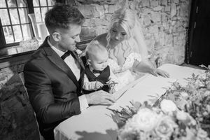 Black and white romantic wedding photography against rustic stone wall background.