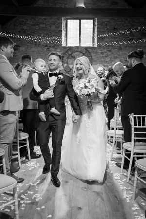 Wedding ceremony moments showing dancing and celebration in a rustic brick venue with string lights.
