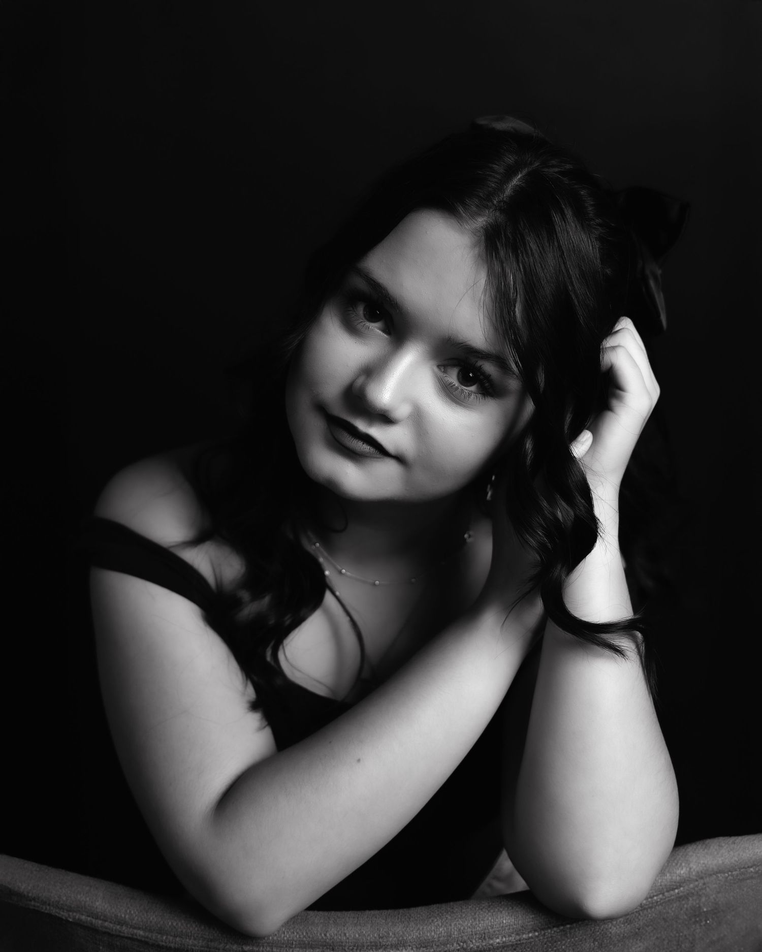 A series of dramatic black and white portraits showing artistic poses with deep shadows and intimate mood.
