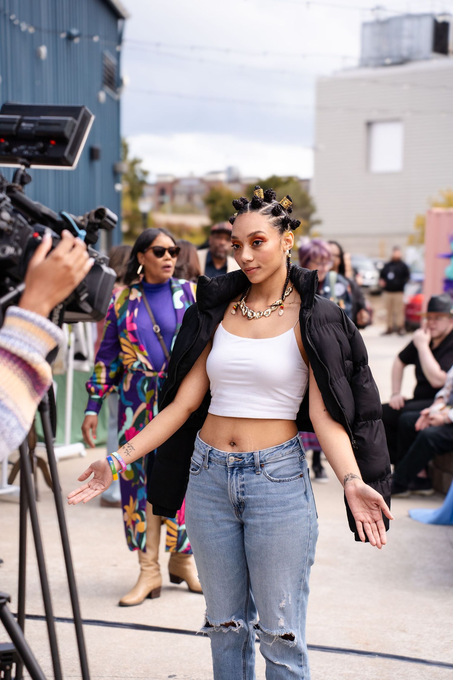 Dancers perform at outdoor event wearing casual streetwear.