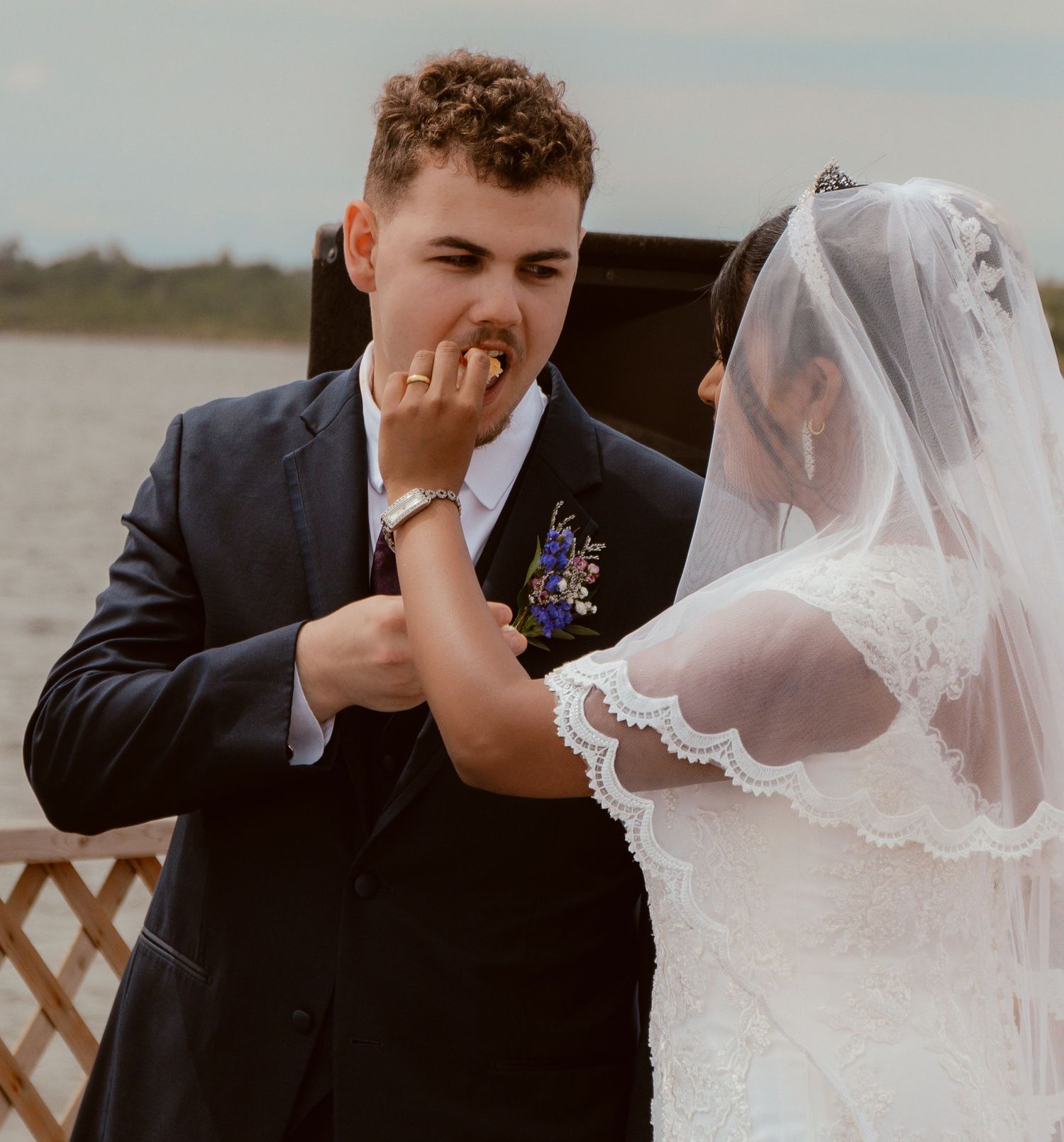 A playful moment during a beachside wedding ceremony.