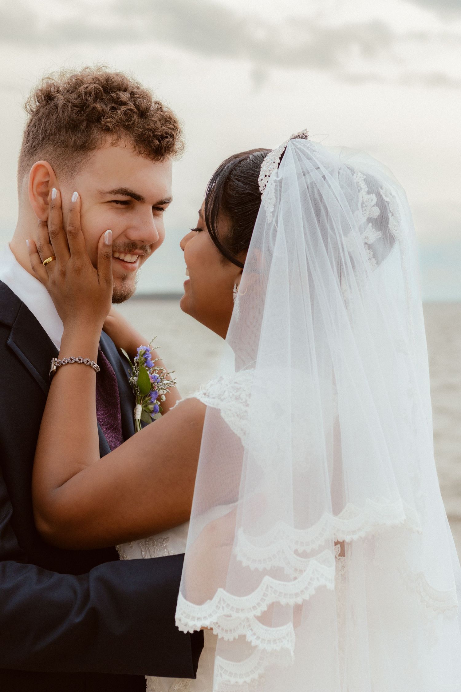 Candid moment between newlyweds during coastal wedding celebration.