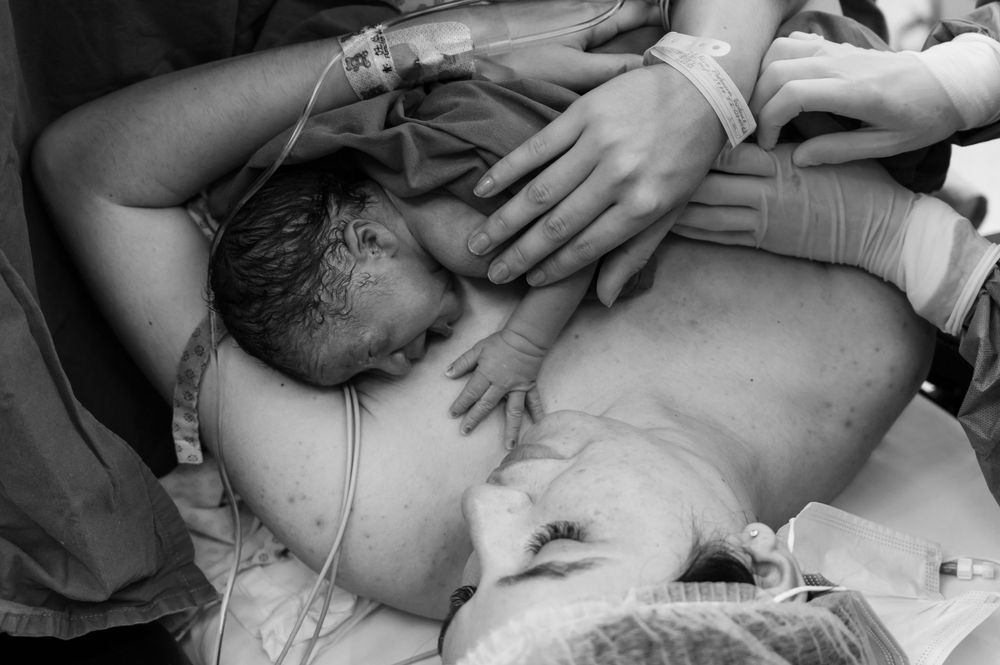 Healthcare team providing immediate care to a newborn in a hospital setting.