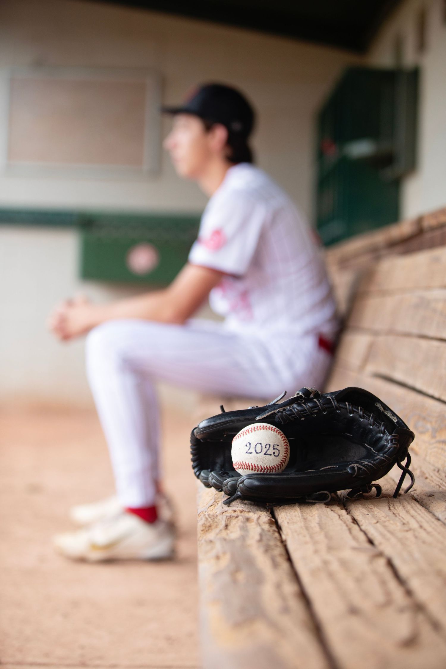 Benet High School Custom Senior Photography by Julie Chen Photography portrait of baseball boy in dugout
