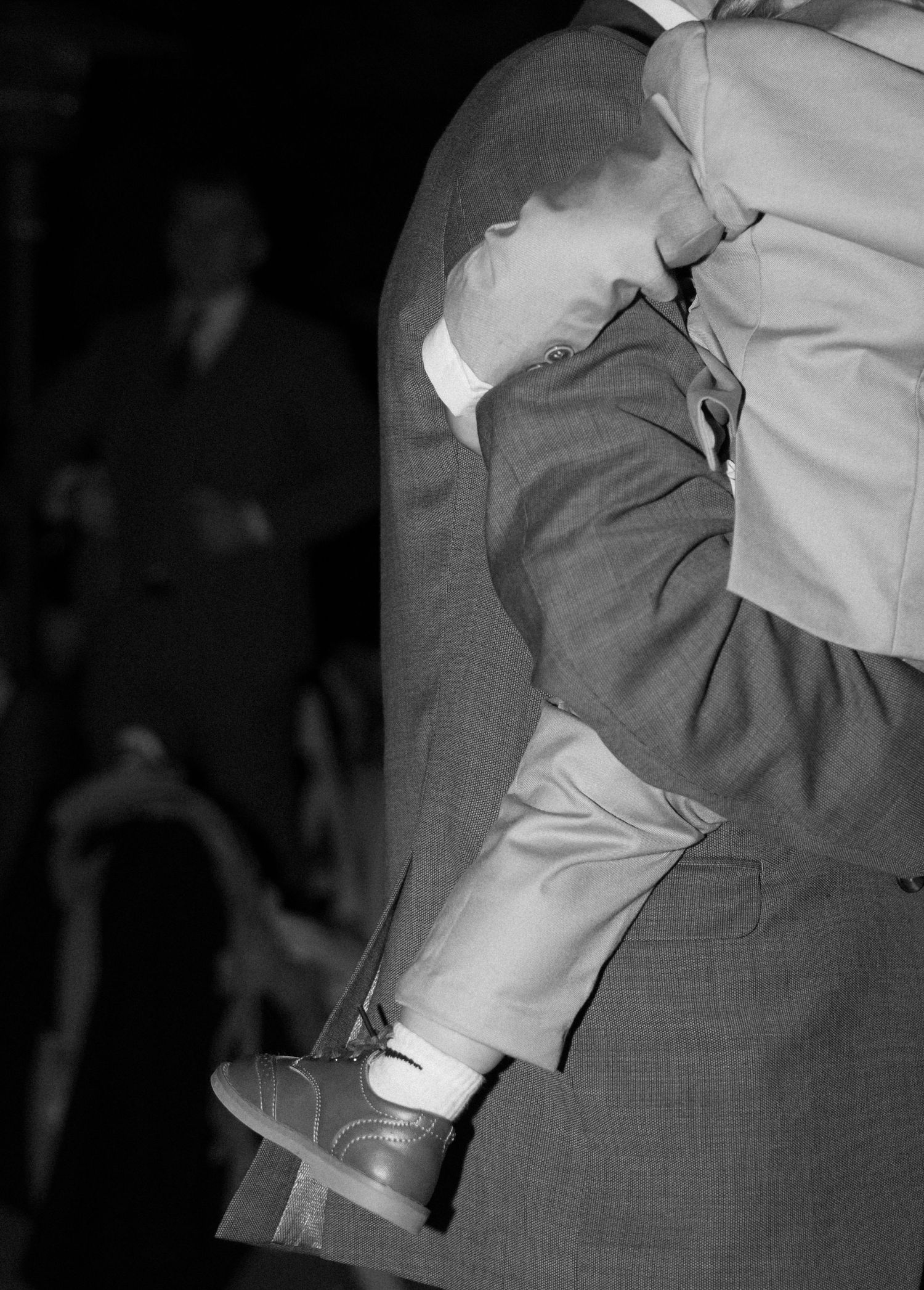 A black and white photograph showing a close-up of two dancers performing a slow dance movement.