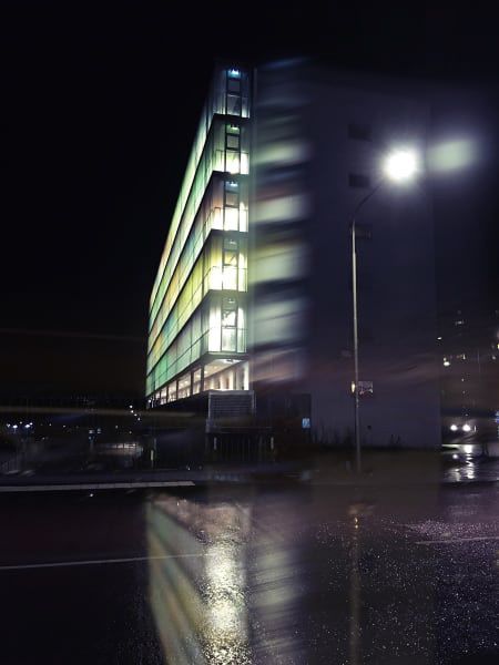 Building with colorful lights shining at night.