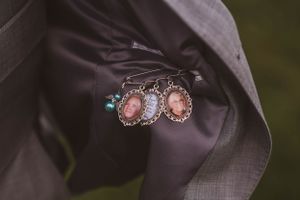 Elegant pink gemstone earrings displayed on dark silk fabric in soft lighting.