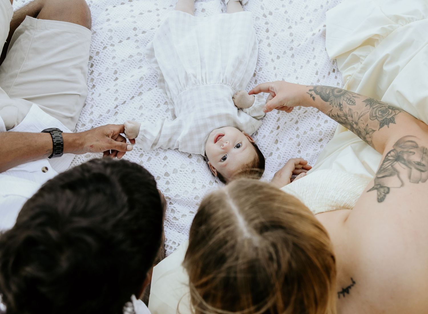 Family playing on a blanket outside