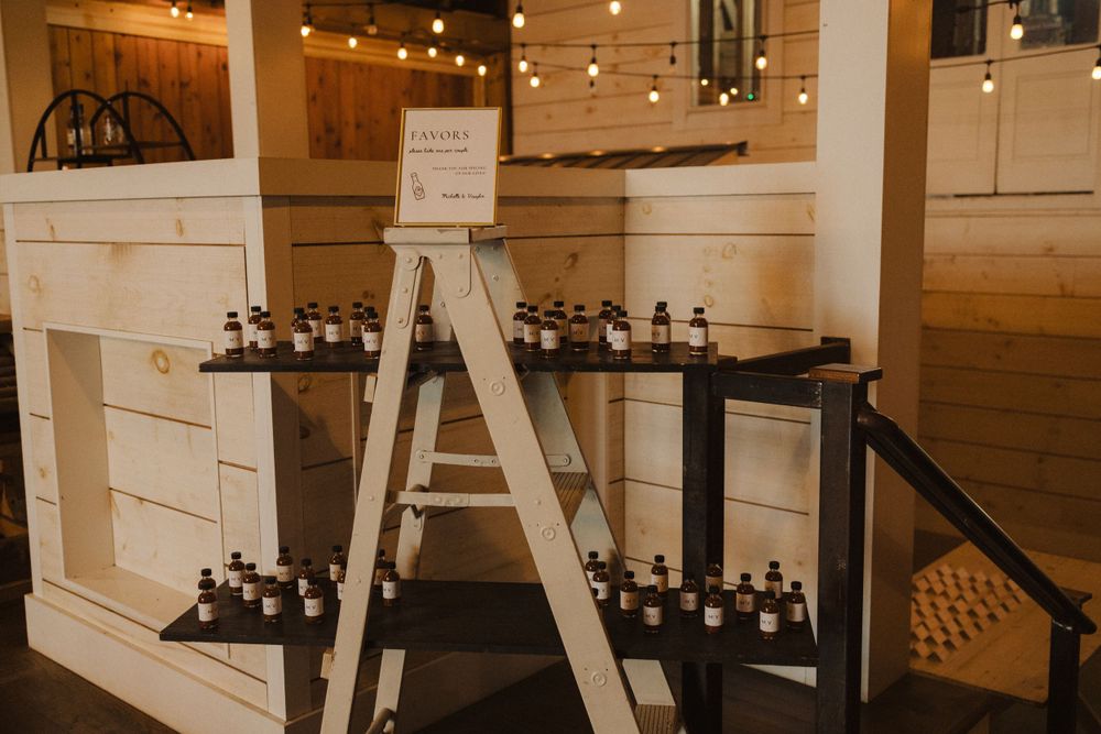 Rustic wooden ladder display showcasing wine bottles under warm string lights in a cozy indoor setting near vernon nj.