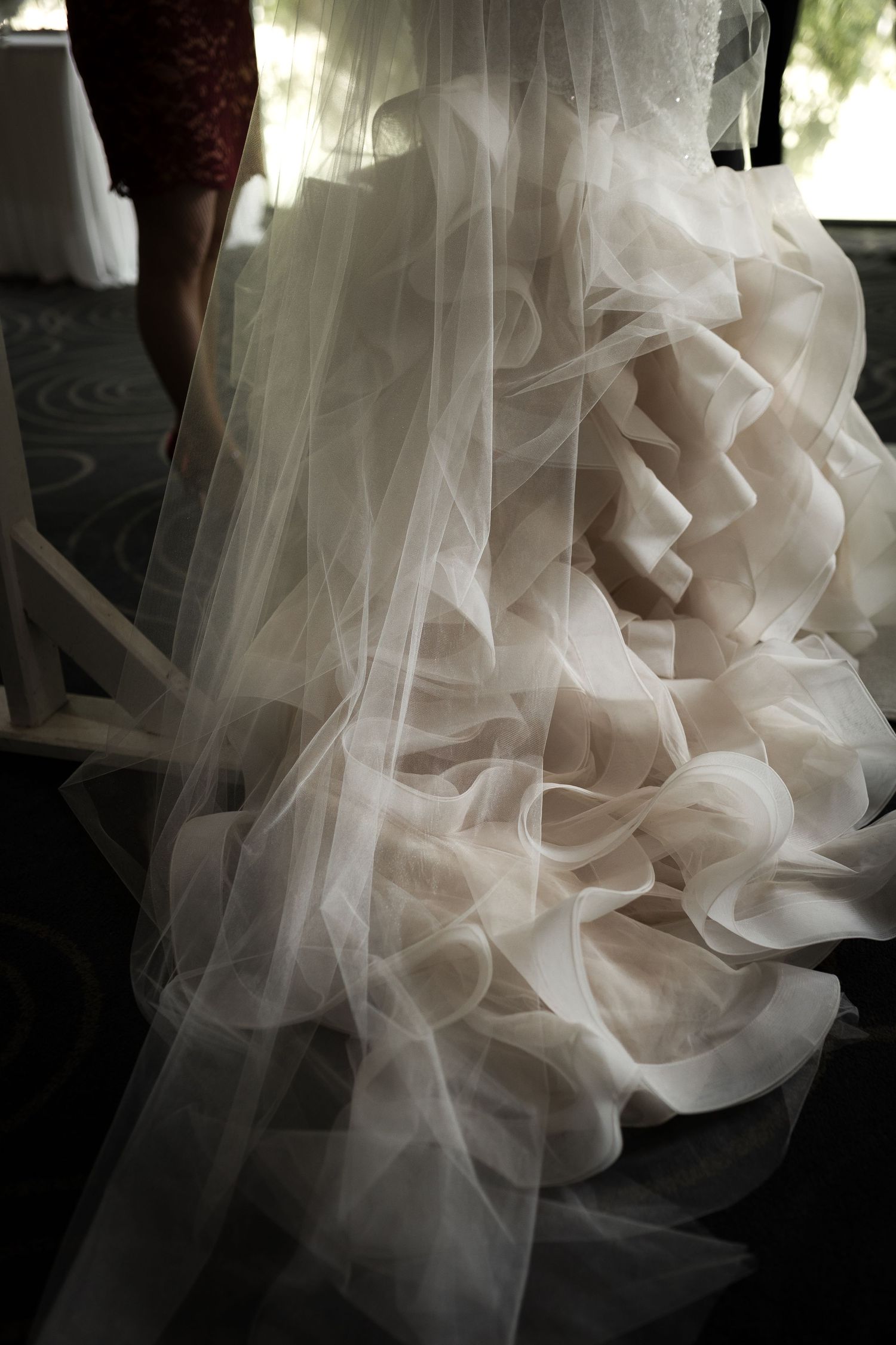 Close-up detail shot of layered tulle and ruffles on a wedding dress.