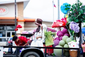 Festival display featuring decorative props, balloons, and colorful party accessories.
