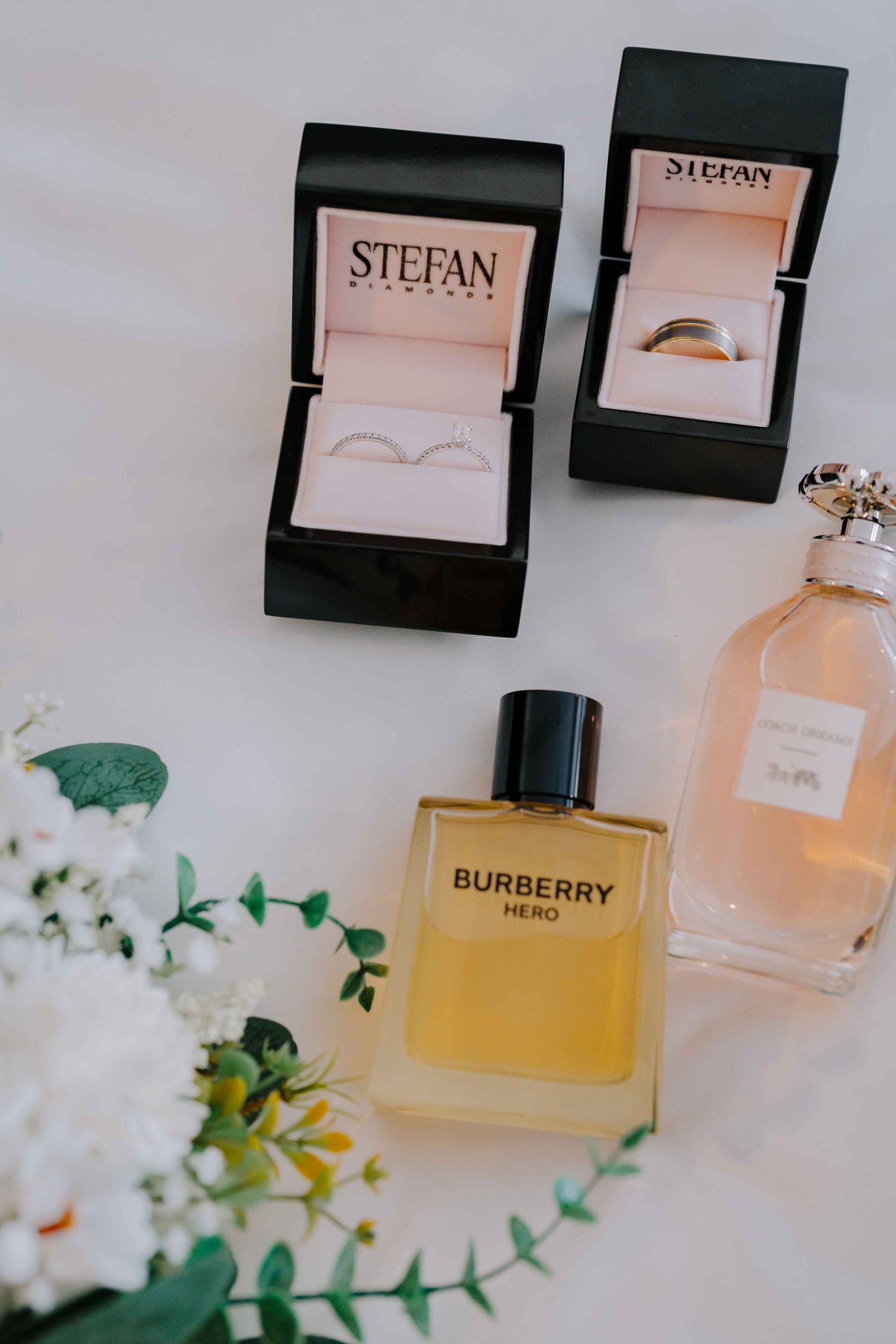 wedding flatlay jewellery and perfume and bouquet