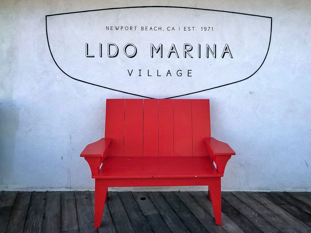 A red wooden lawn chair in Lido Marina