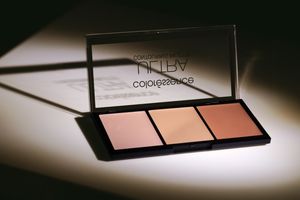 Coloressence makeup palette with three warm-toned blush and highlighter shades displayed open with mirror reflection.