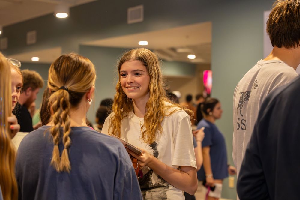 Students socializing in a casual indoor gathering space.
