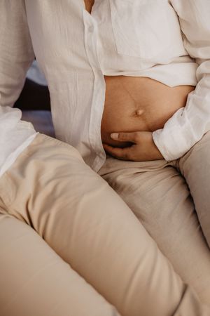 Intimate minimalist photography featuring soft white fabric and natural lighting.