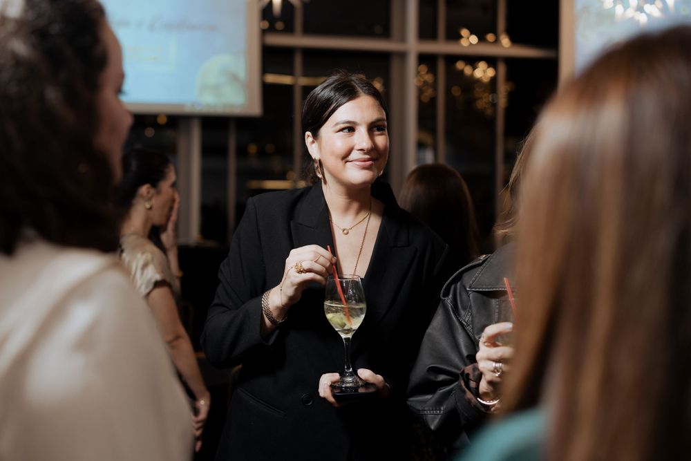 People enjoying drinks and conversation at an elegant evening social gathering.