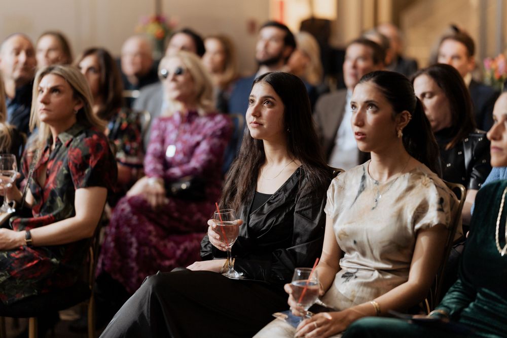 An attentive audience seated in rows during a professional conference or event.