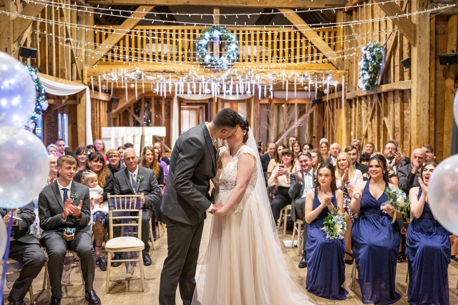 First kiss at a wedding in a barn wedding venue. Gwynedd wedding photographer