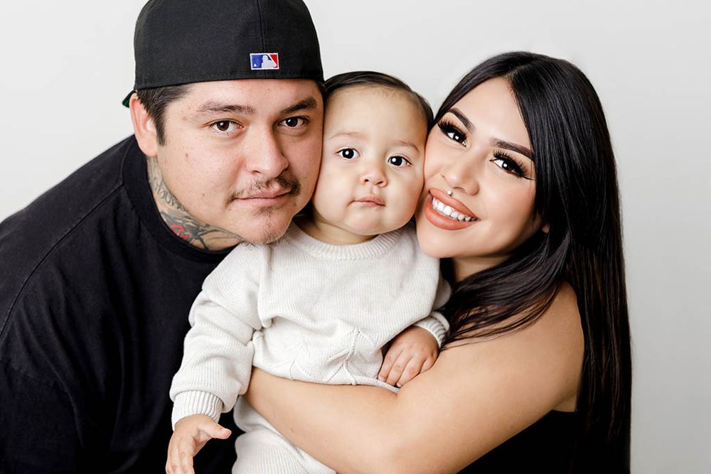 Family and baby photographer in Winchester California - Happy parents hold their baby boy in a sweet family portrait.